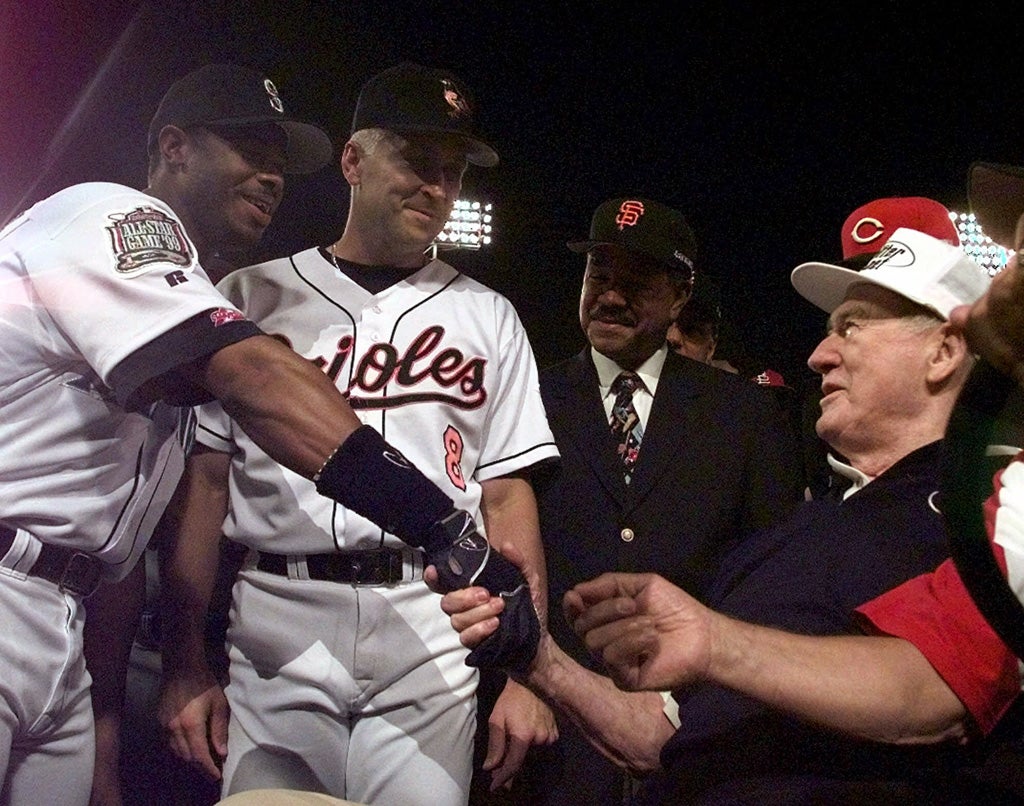 Baseball legend Ted Williams smiles as he shakes the hands of All-Stars 