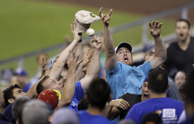 Fans try to catch a foul ball  