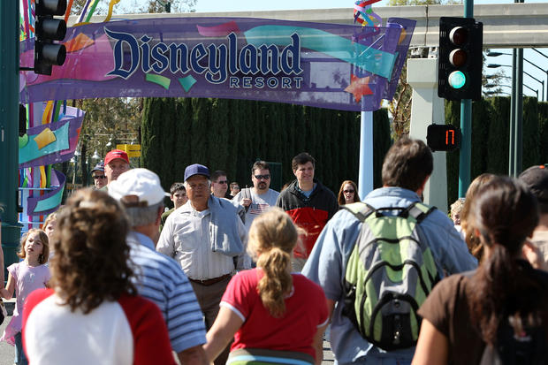 Tourists walk near entrance to Disneyland Resort in Anaheim 