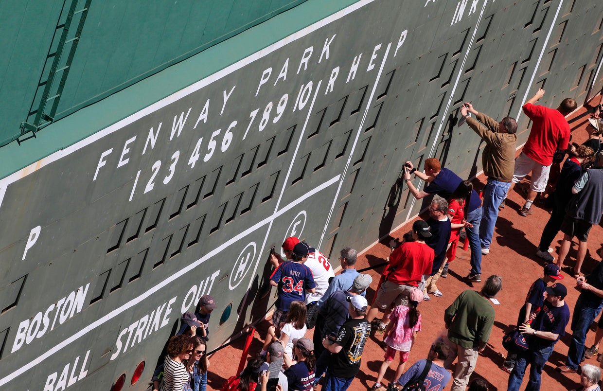 People view the scoreboard section of the Green Monster left field 