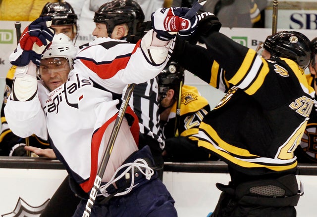 Alex Ovechkin is hit by Dennis Seidenberg 
