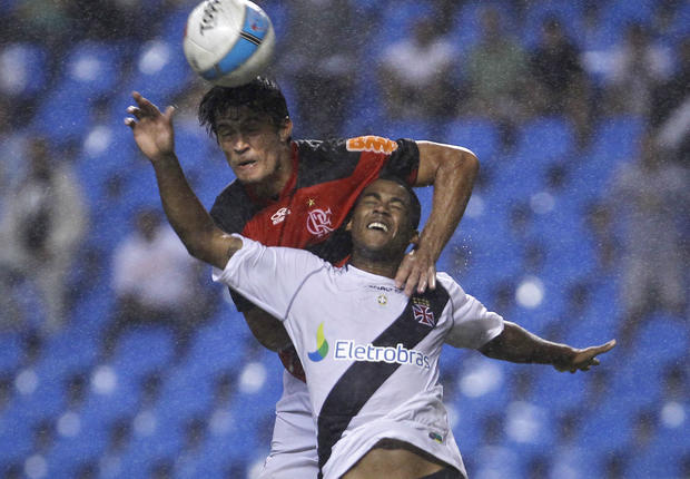Flamengo's Gonzalez, top, and Vasco da Gama's Renato Silva, bottom, jump for a high ball  