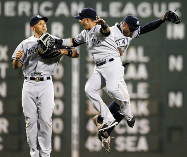 outfielders Raul Ibanez, Nick Swisher and Curtis Granderson celebrate  