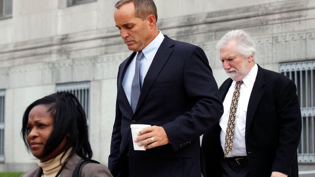 Andrew Young, center, a former aide to John Edwards, leaves federal court in Greenboro, N.C. with a federal official and attorney David Geneson, right, earlier this week 
