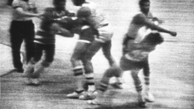 In this Dec. 9, 1977, file image made from a television frame, Los Angeles Lakers' Kermit Washington, right, throws a punch to the jaw of Houston Rockets' Rudy Tomjanovich during an NBA basketball game in Los Angeles. 