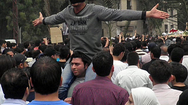 An anti-Syrian regime mourner shouts slogans April 30, 2012, during the funeral procession of the activist Nour al-Zahraa, 23, who was shot by Syrian security forces in Damascus, Syria. 