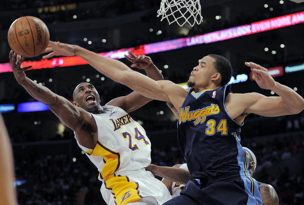 Kobe Bryant puts up a shot as JaVale McGee defends 