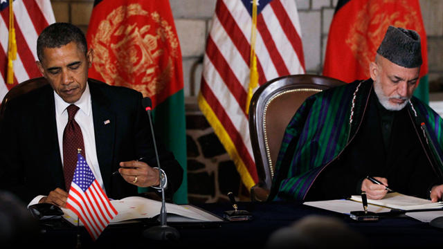 President Barack Obama and Afghan President Hamid Karzai sign a strategic partnership agreement at the presidential palace in Kabul, Afghanistan, Wednesday, May 2, 2012. 