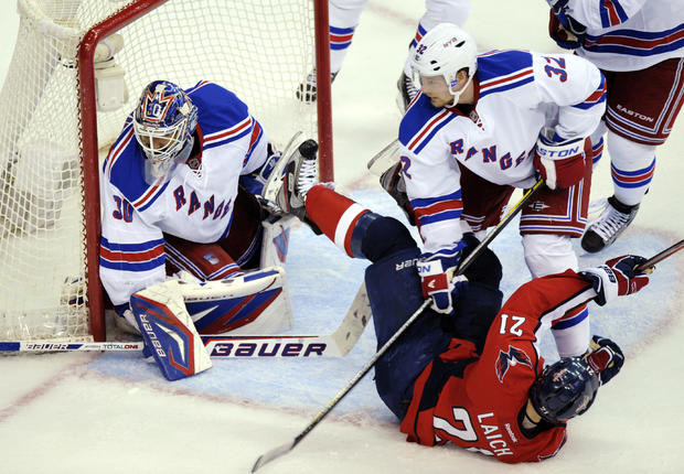 Brooks Laich gets tripped up in front of New York Rangers goalie Henrik Lundqvist 