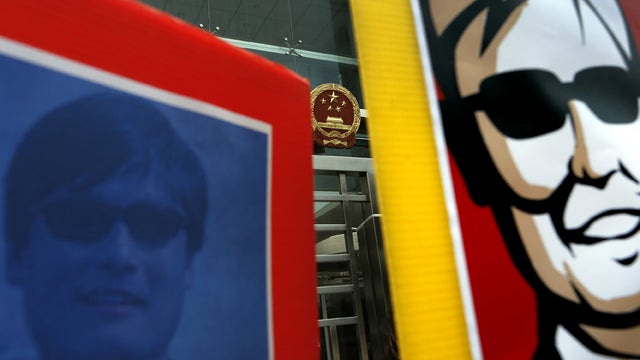 Two images featuring blind Chinese activist Chen Guangcheng are seen during a protest in front of the Chinese central government's liaison in Hong Kong May 4, 2012. 