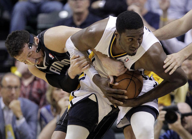 Hedo Turkoglu and Roy Hibbert tussle for control of the ball  