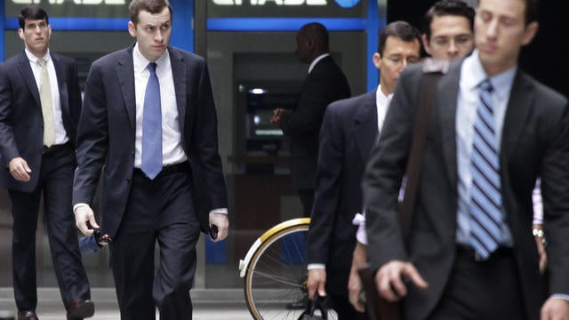 People arrive at JPMorgan Chase headquarters in New York Monday, May 14, 2012. JPMorgan, the largest bank in the United States, is seeking to minimize the damage caused by a $2 billion trading loss, disclosed Thursday by CEO Jamie Dimon. 