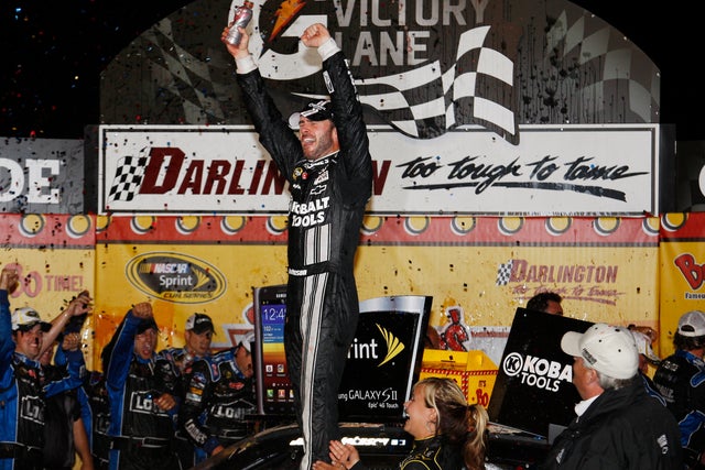 Jimmie Johnson celebrates in victory lane  