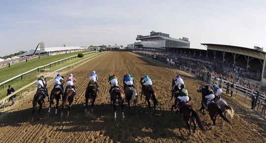 In this image taken with a fisheye lens, the field breaks from the starting gate for the 137th Preakness Stakes horse race 