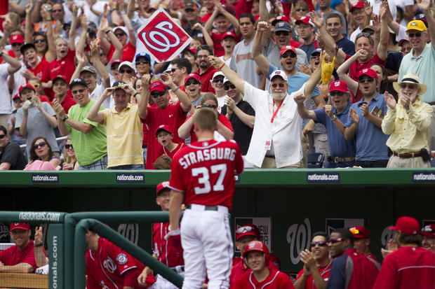 Stephen Strasburg waves to the crowd after hitting his first career home run  