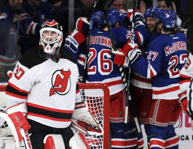 Martin Brodeur looks up as New York Rangers players celebrate 