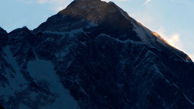 Clouds hover above the world's highest peak, Mount Everest, as seen from Syangboche, Nepal, May 19, 2010. 