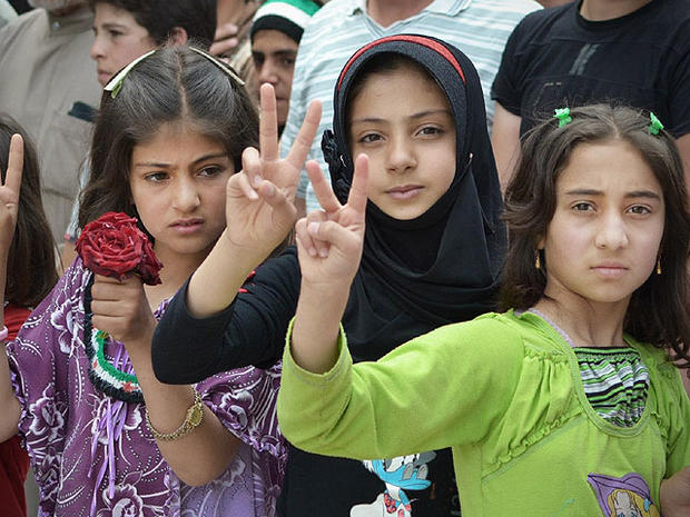 In this citizen journalism image taken on Tuesday, May 29, 2012 and provided by Edlib News Network ENN, Syrian girls flash victory signs during a demonstration in Kfarnebel, Idlib province, northern Syria. 