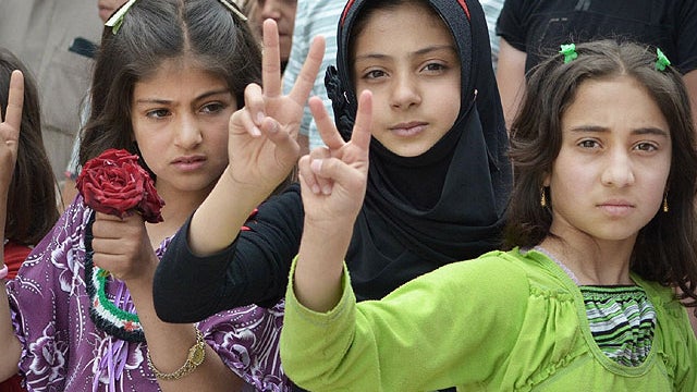 In this citizen journalism image taken on Tuesday, May 29, 2012 and provided by Edlib News Network ENN, Syrian girls flash victory signs during a demonstration in Kfarnebel, Idlib province, northern Syria. 