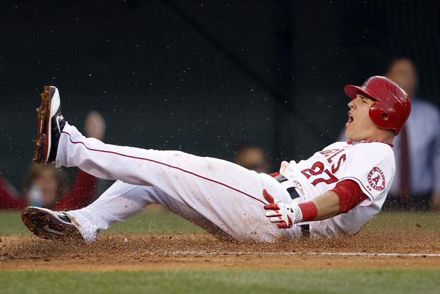 Mike Trout slides across home plate 