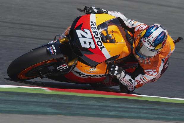 Dani Pedrosa steers his motorcycle during qualifying sessions  