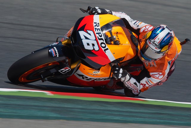 Dani Pedrosa steers his motorcycle during qualifying sessions  