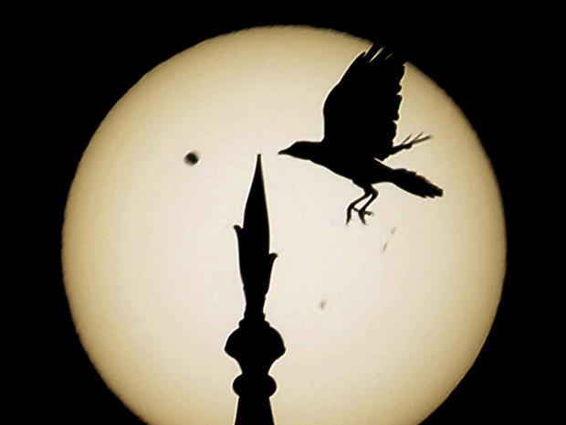 Venus passes in front of the sun, as seen from the Taj Mahal, in India 