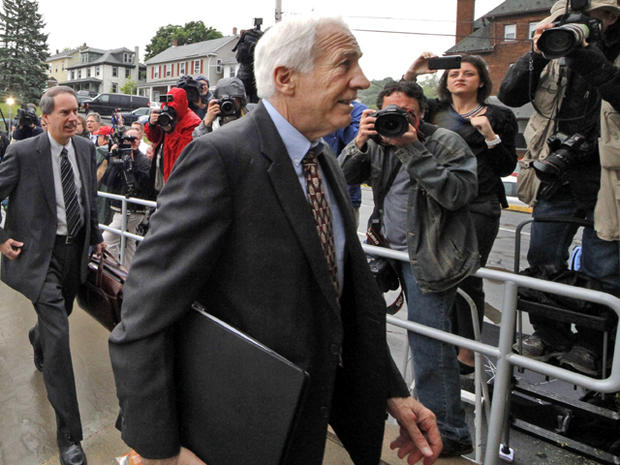 Former Penn State University assistant football coach Jerry Sandusky, center, arrives with his attorney Joe Amendola June 5, 2012, for the first day of jury selection at a courthouse in Bellefonte, Pa. 
