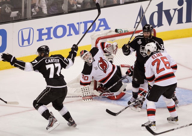 Martin Brodeur reacts as Jeff Carter celebrates 