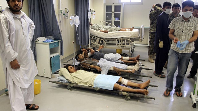 Afghan victims of a suicide attack are seen on stretchers at a hospital in Kandahar 