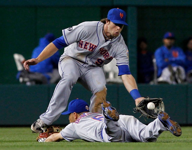 Kirk Nieuwenhuis jumps over shortstop Omar Quintanilla 