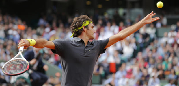 Roger Federer serves in his semi final 