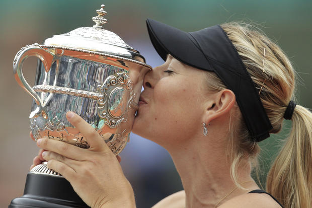 Maria Sharapova of Russia holds the trophy after winning the women's final match 