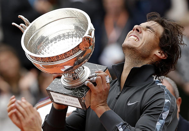 Spain's Rafael Nadal holds the cup after defeating Serbia's Novak Djokovic  