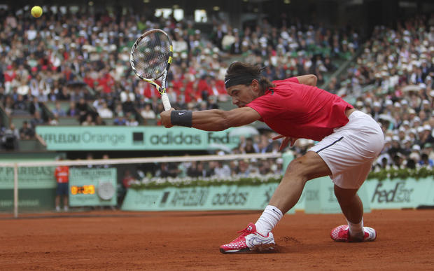 Rafael Nadal returns the ball to Novak Djokovic  