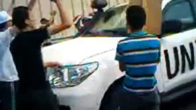 This image made from amateur video released by Free Lattakia and accessed June 12, 2012, purports to show Syrians preventing U.N. observers from entering Haffa, Syria. 
