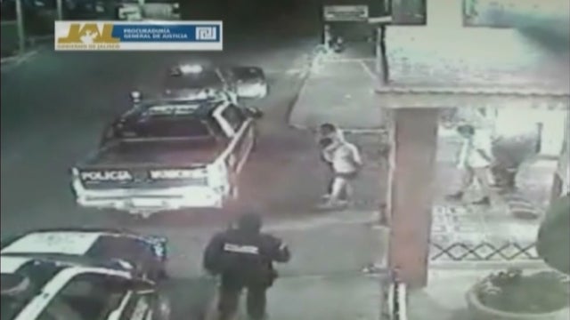 In this frame grab taken from video filmed by a surveillance camera on Jan 20, 2012, shows three men walk away from a hotel in their underwear with their hands tied behind their backs and some blindfolded, as they are led by men dressed in police uniforms 