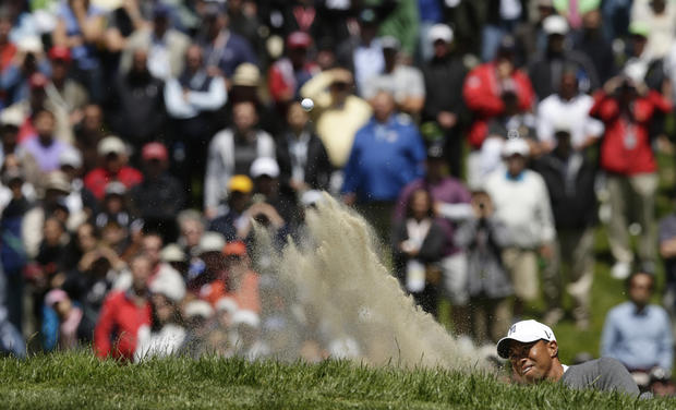 Tiger Woods hits out of a bunker 