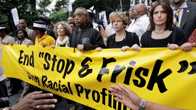 The Rev. Al Sharpton, center, walks with demonstrators during a silent march to end the "stop-and-frisk" program in New York, on June 17, 2012. 
