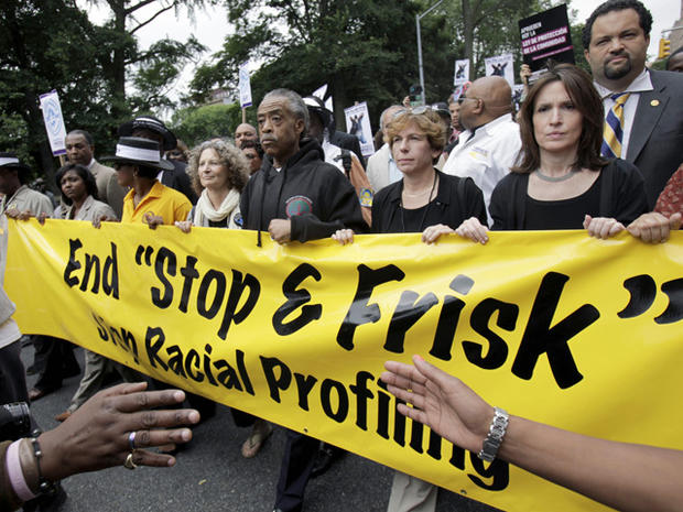 The Rev. Al Sharpton, center, walks with demonstrators during a silent march to end the "stop-and-frisk" program in New York, on June 17, 2012. 