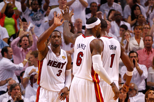 Dwyane Wade (3), LeBron James (6)  and Chris Bosh (1) of the Miami Heat react  