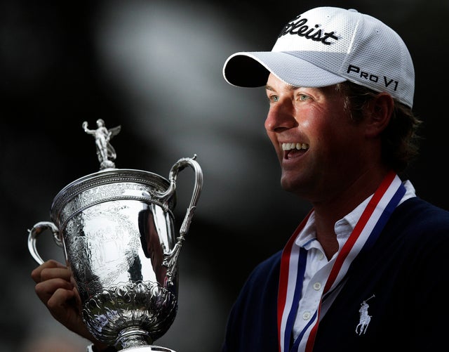 Webb Simpson holds up the championship trophy 
