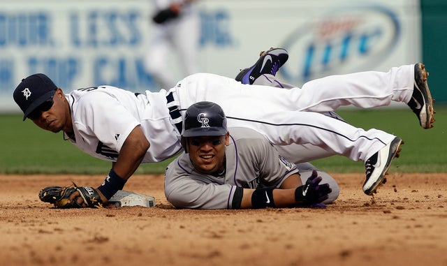 Ramon Santiago and Carlos Gonzalez watch after Santiago completed the double play  