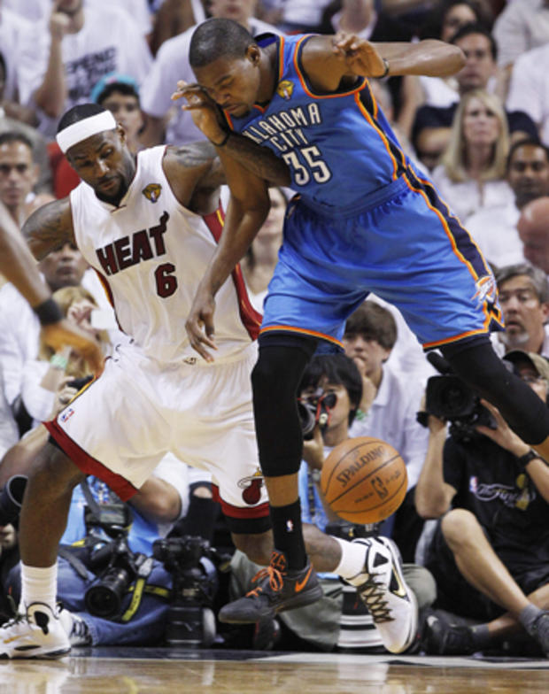 LeBron James and Kevin Durant go after a loose ball  