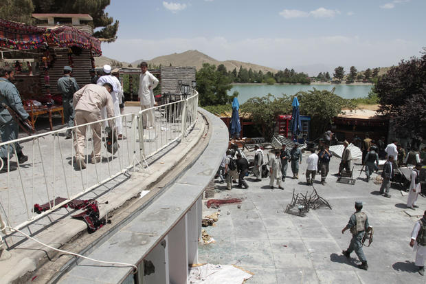 Afghan security forces and civilians are seen at the Spozhmai hotel on Lake Qurgha 
