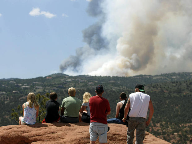 People watch as smoke billows from a wildfire west of Colorado Springs, Colo. on Saturday, June 23, 2012. 