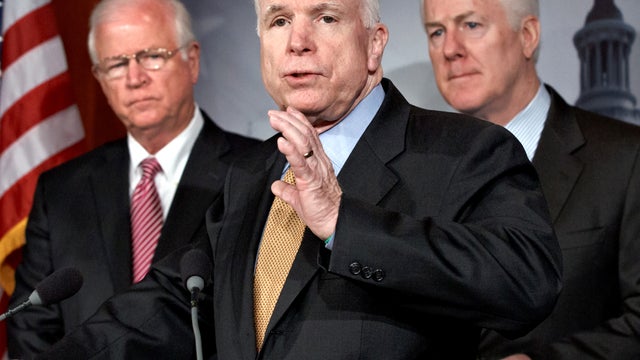 Sen. John McCain, R-Ariz., flanked by Sen. Saxby Chambliss, R-Ga., left and vice chair of the Senate Intelligence Committee, and Sen. John Cornyn, R-Texas, speaks during a news conference on Capitol Hill in Washington June 26, 2012. 