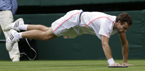 Ernests Gulbis dives for the ball  
