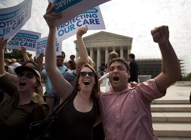 Claire McAndrew of Washington, left, and Donny Kirsch of Washington, celebrate outside the Supreme Court 