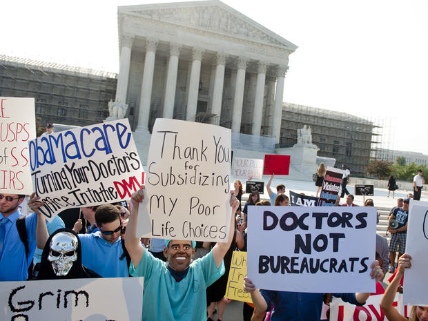 Health care activists swarm SCOTUS steps 